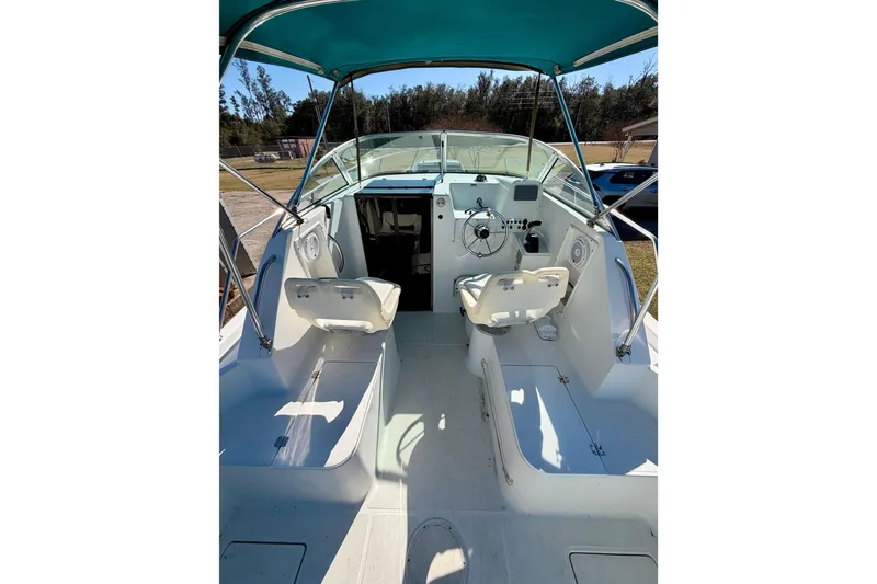 Slide: The Image of 2019 Aquasport 215 Explorer boat interior with seating and steering wheel. - 4