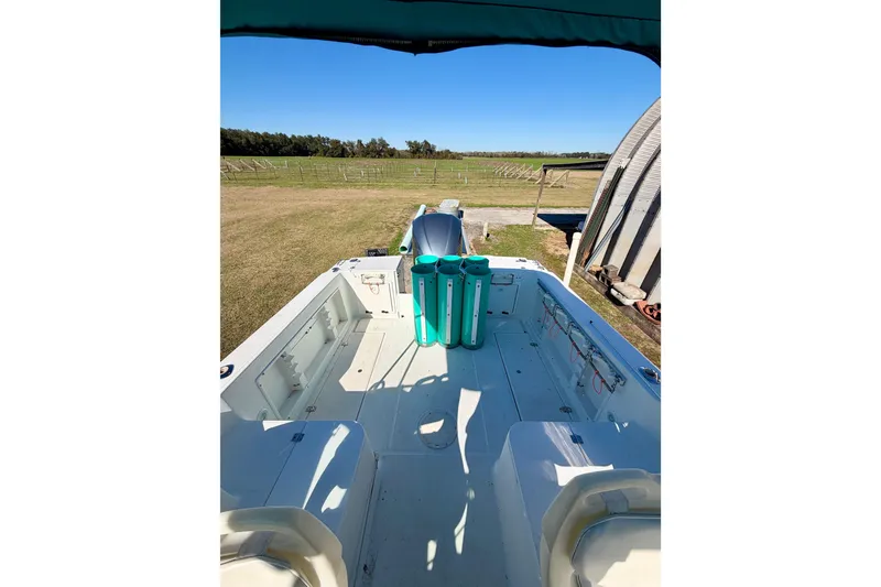 Slide: The Image of 2019 Aquasport 215 Explorer boat interior with open deck and countryside view. - 5