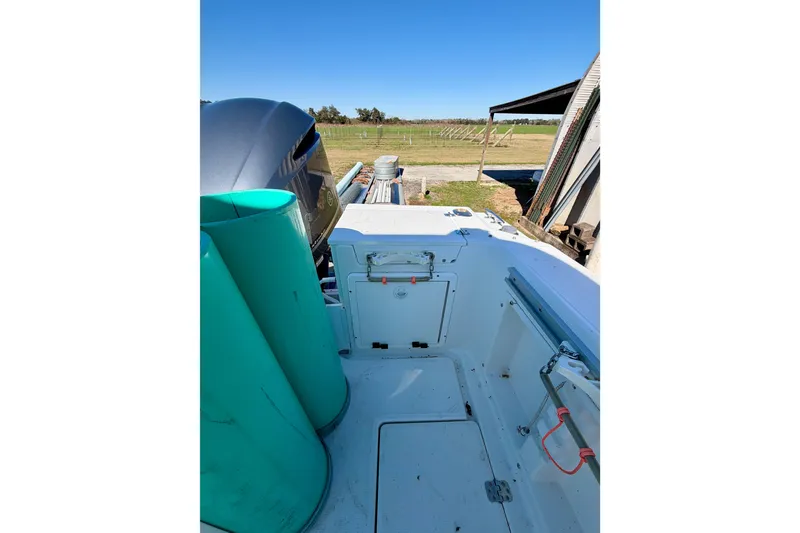 Slide: The Image of 2019 Aquasport 215 Explorer boat interior with storage compartments and equipment. - 7