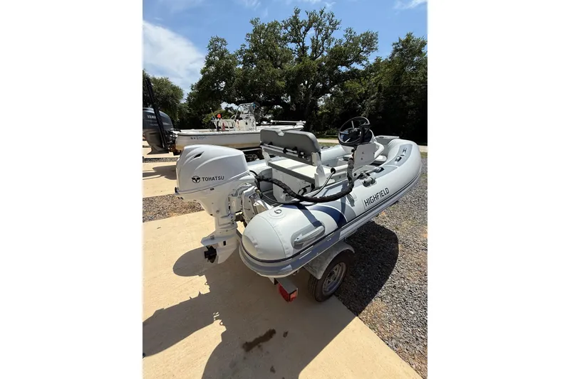 Slide: The Image of 2026 Highfield Classic 310 FCT inflatable boat with Tohatsu outboard motor on trailer. - 3