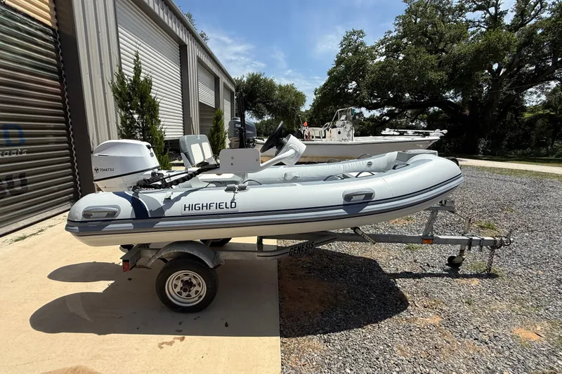 The Image of 2026 Highfield Classic 340 FCT inflatable boat on trailer, parked outdoors. - 1