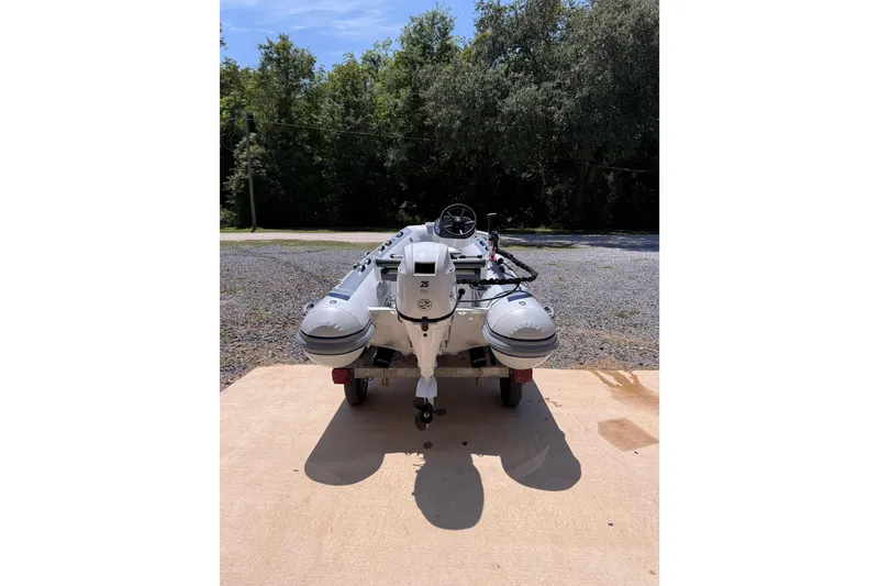 Slide: The Image of 2026 Highfield Classic 340 FCT inflatable boat on trailer, parked outdoors. - 3