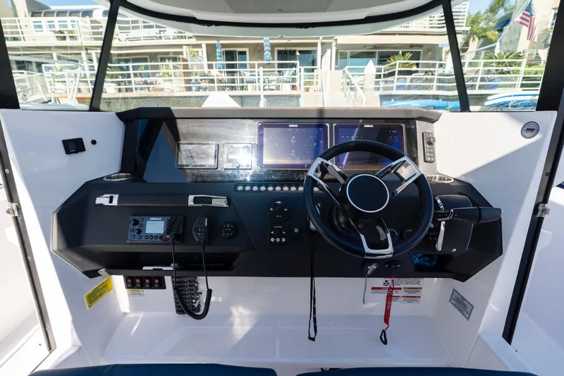 Slide: The Image of 2024 Axopar 29 XC Cross Cabin helm with modern controls and navigation displays. - 18