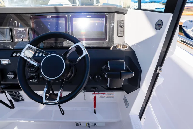 Slide: The Image of 2024 Axopar 29 XC Cross Cabin helm with modern controls and dual displays. - 19