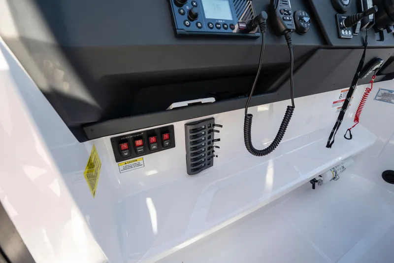 Slide: The Image of 2024 Axopar 29 XC Cross Cabin dashboard with controls and communication devices. - 21