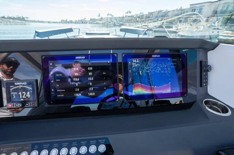 Slide: The Image of 2024 Axopar 29 XC Cross Cabin dashboard with Simrad navigation displays. - 22