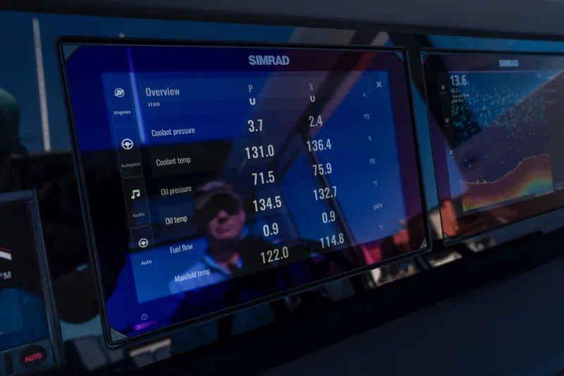 Slide: The Image of Simrad display on 2024 Axopar 29 XC Cross Cabin showing engine metrics and navigation data. - 24