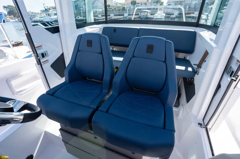 Slide: The Image of 2024 Axopar 29 XC Cross Cabin interior with blue seating and modern design. - 28