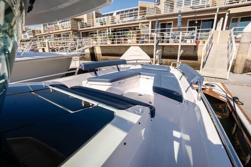 Slide: The Image of 2024 Axopar 29 XC Cross Cabin boat docked, featuring spacious seating and modern design. - 35