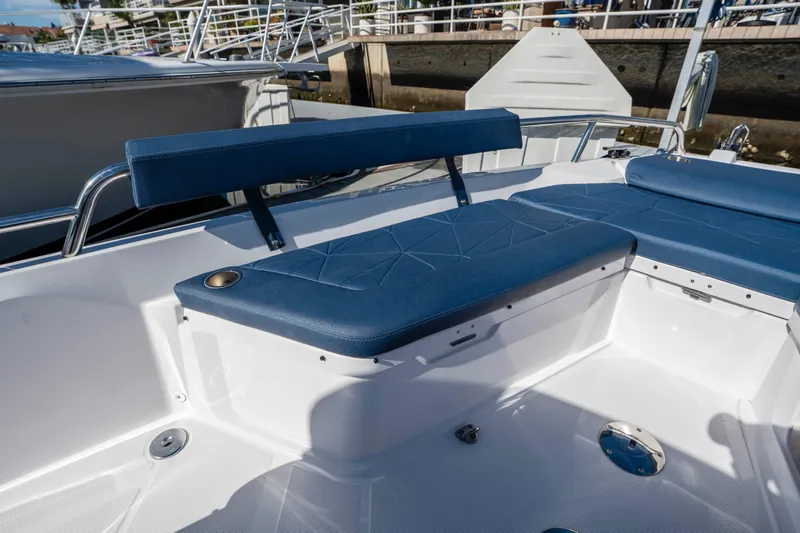 Slide: The Image of 2024 Axopar 29 XC Cross Cabin boat seating area with blue cushions. - 37