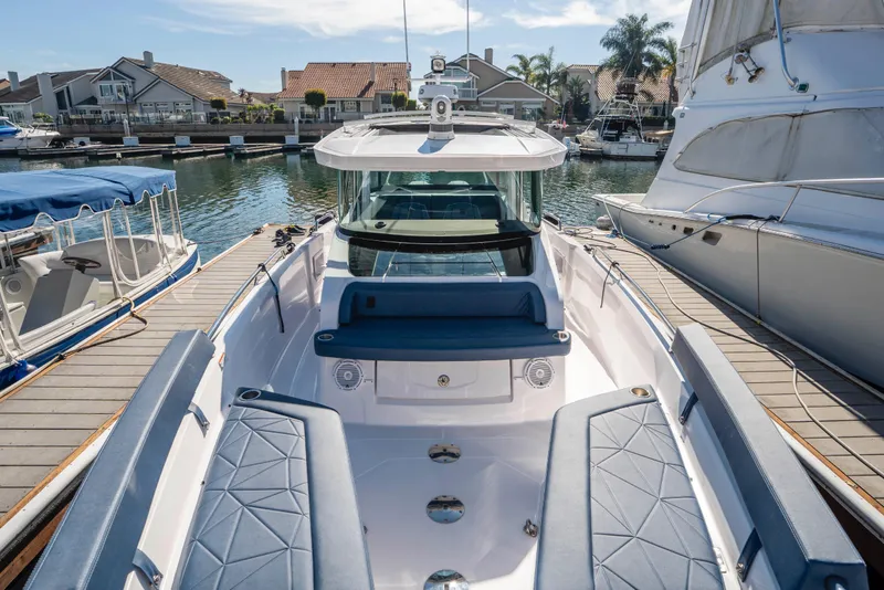 Slide: The Image of 2024 Axopar 29 XC Cross Cabin docked, showcasing sleek design and spacious seating. - 43