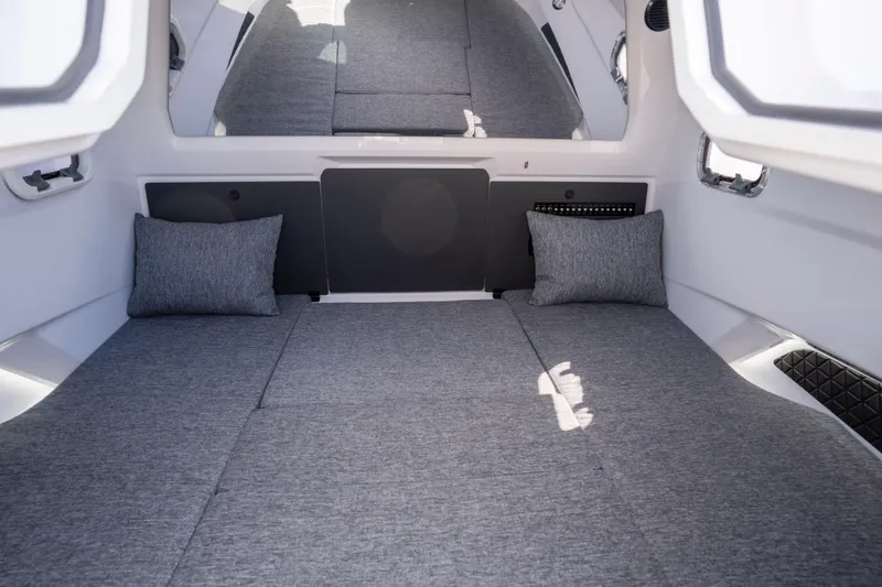 Slide: The Image of 2024 Axopar 29 XC Cross Cabin interior with gray cushions and pillows. - 45