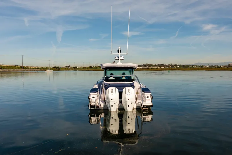 Slide: The Image of 2024 Axopar 29 XC Cross Cabin boat on calm water, rear view. - 5