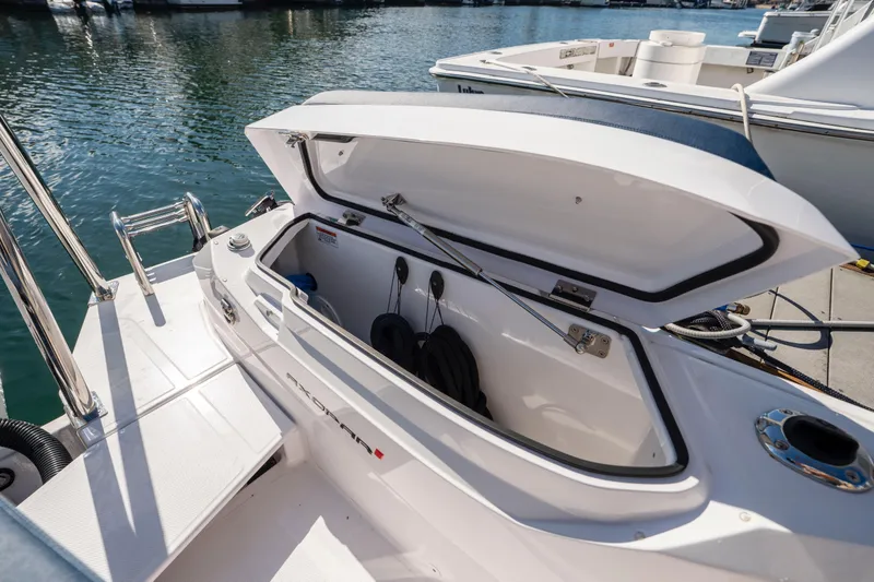 Slide: The Image of 2024 Axopar 29 XC Cross Cabin boat storage compartment open at dock. - 51