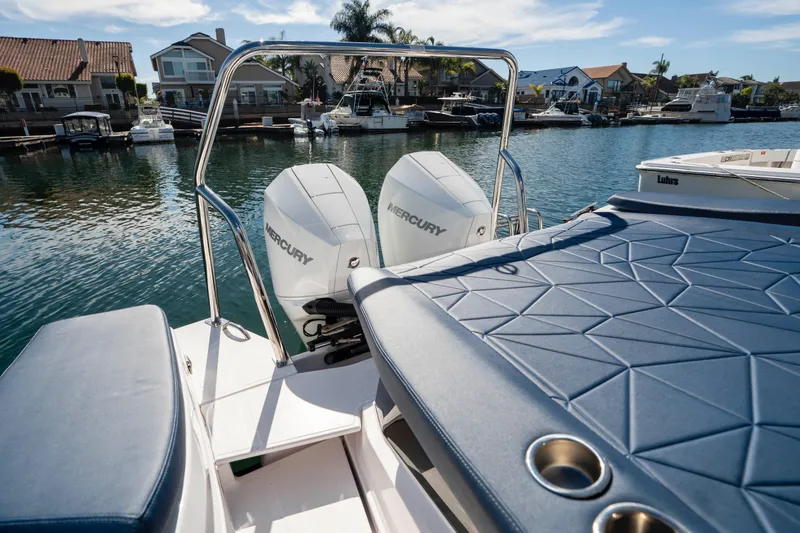 Slide: The Image of 2024 Axopar 29 XC Cross Cabin with Mercury engines docked in a scenic marina. - 55