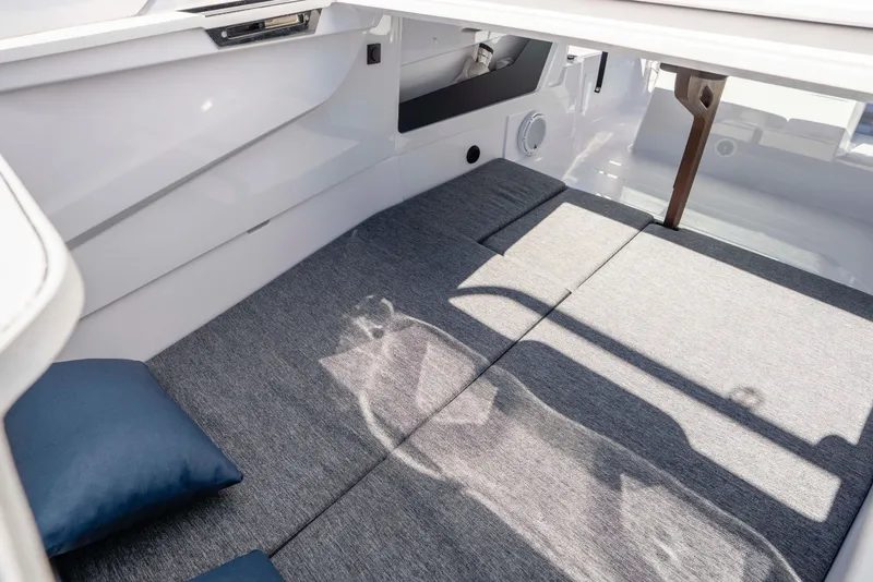 Slide: The Image of 2024 Axopar 29 XC Cross Cabin interior with gray cushions and modern design. - 57