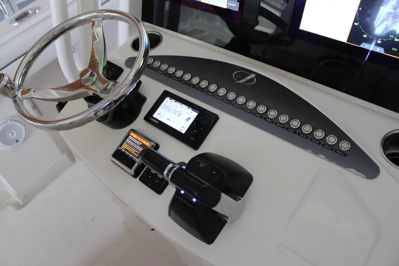 Slide: The Image of Control panel of a 2018 Jupiter 30 HFS boat with steering wheel and electronic displays. - 4