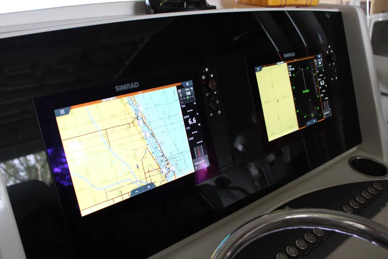 Slide: The Image of Simrad navigation displays on 2018 Jupiter 30 HFS boat dashboard. - 7