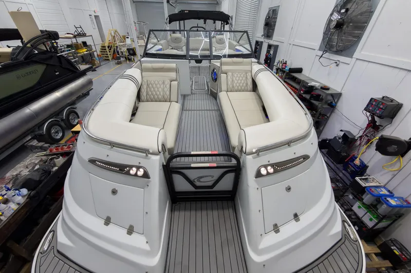 Slide: The Image of 2020 Crest Continental 270 NX-L Twin boat interior with luxurious seating in a workshop setting. - 10