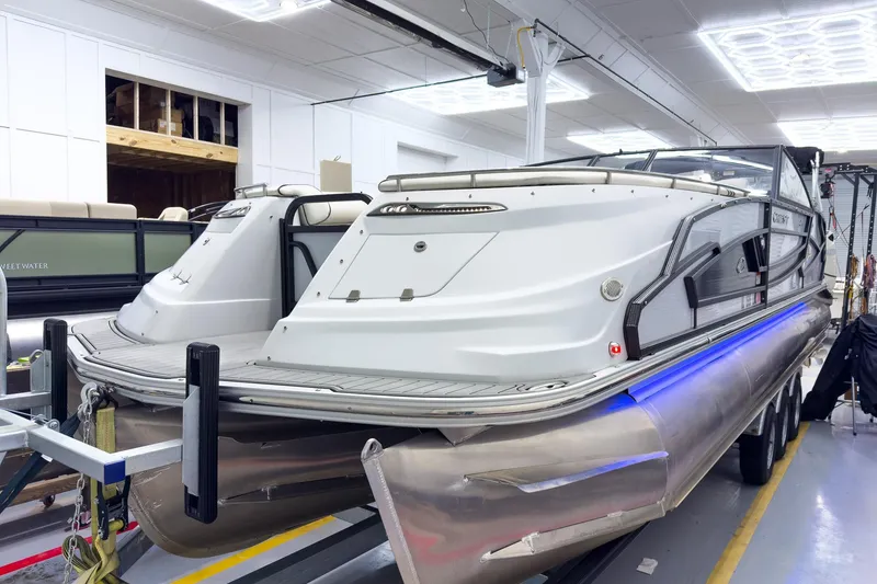 Slide: The Image of 2020 Crest Continental 270 NX-L Twin pontoon boat in a showroom setting. - 2