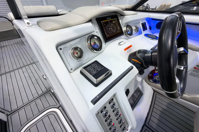 Slide: The Image of 2020 Crest Continental 270 NX-L Twin boat dashboard with modern controls and steering wheel. - 25