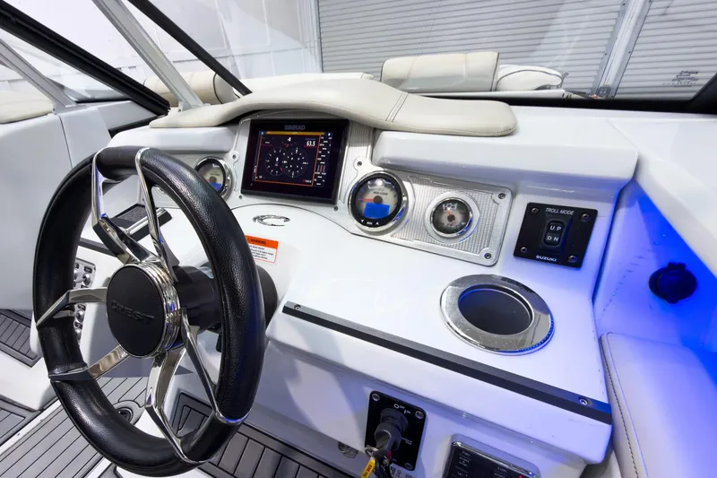 Slide: The Image of 2020 Crest Continental 270 NX-L Twin boat dashboard with steering wheel and control panel. - 26