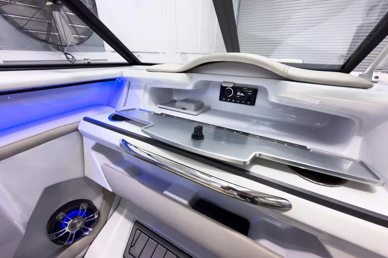 Slide: The Image of Interior of 2020 Crest Continental 270 NX-L Twin boat with modern dashboard and blue LED lighting. - 28