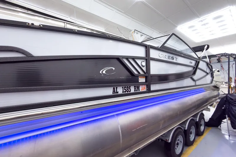 Slide: The Image of 2020 Crest Continental 270 NX-L Twin pontoon boat with sleek design and blue LED lighting. - 3