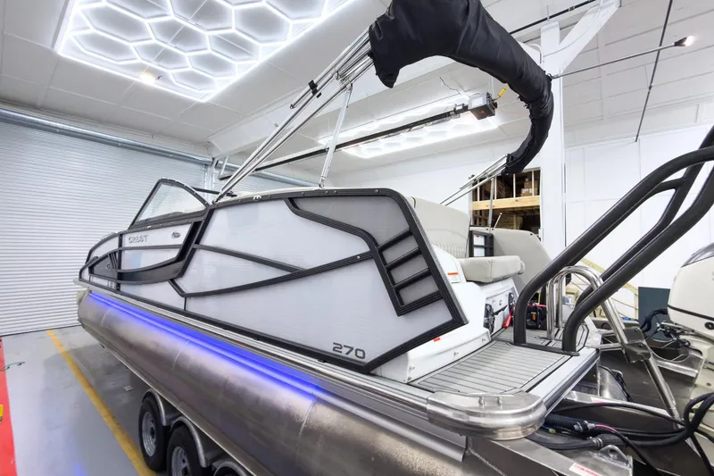 Slide: The Image of 2020 Crest Continental 270 NX-L Twin pontoon boat in a showroom setting. - 4