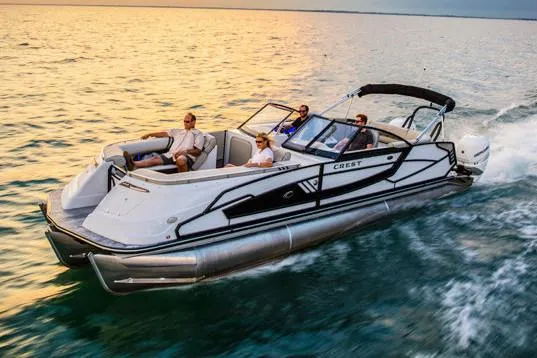 Slide: The Image of Manufacturer Provided Image: 2020 Crest Continental 270 NX-L Twin pontoon boat cruising on water at sunset. - 44
