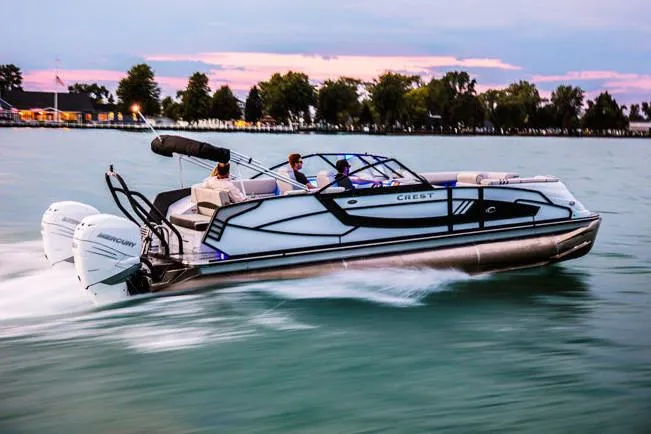 Slide: The Image of Manufacturer Provided Image: 2020 Crest Continental 270 NX-L Twin pontoon boat cruising on a lake at sunset. - 45
