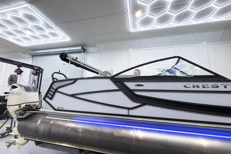 Slide: The Image of 2020 Crest Continental 270 NX-L Twin boat in modern showroom with Suzuki engine. - 7