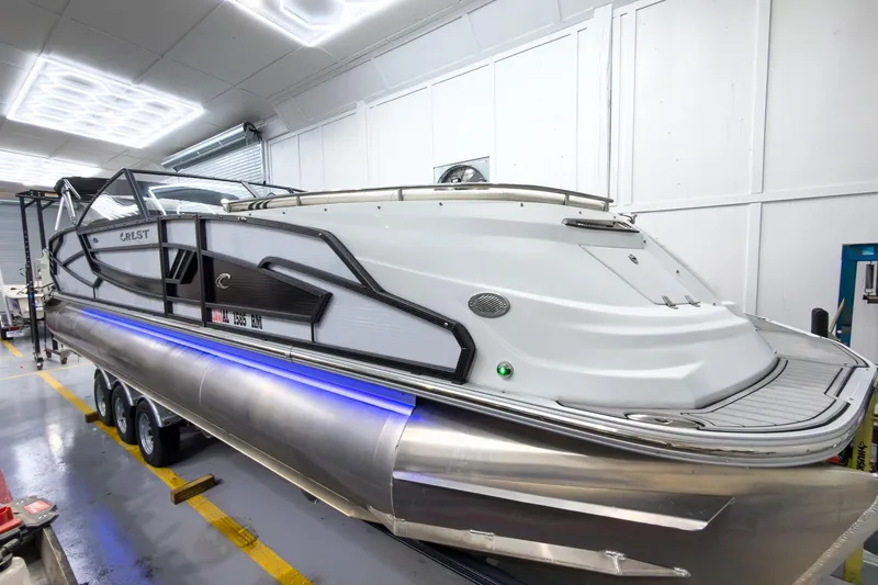 Slide: The Image of 2020 Crest Continental 270 NX-L Twin pontoon boat in a showroom setting. - 9