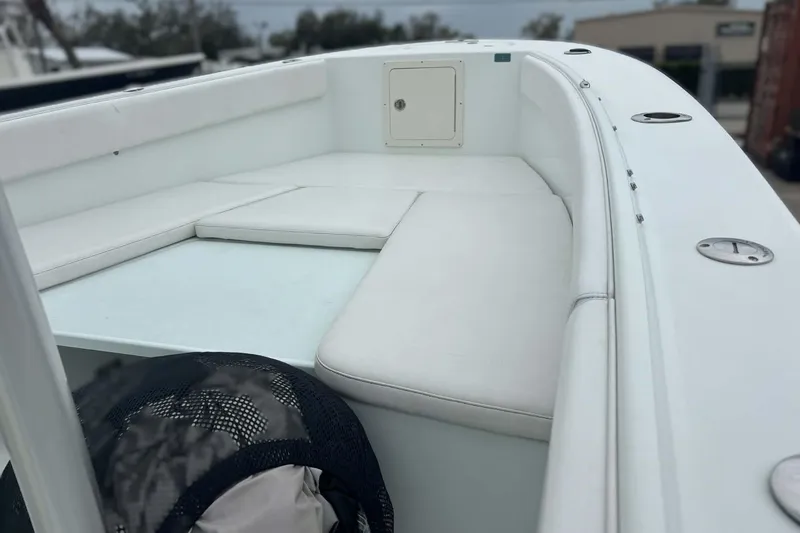 Slide: The Image of 2014 Andros Tarpon 26 boat interior with white cushioned seating. - 10