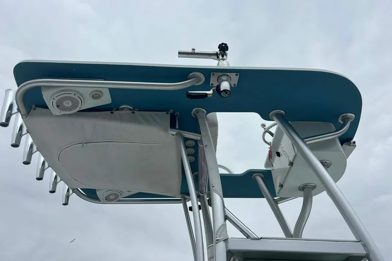 Slide: The Image of 2014 Andros Tarpon 26 boat tower with speakers and rod holders against cloudy sky. - 12