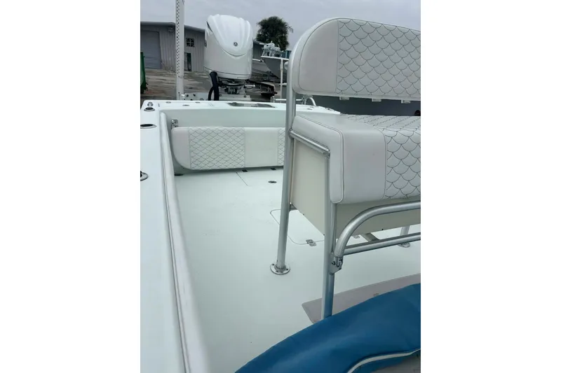 Slide: The Image of 2014 Andros Tarpon 26 boat interior with white seating and sleek design. - 13