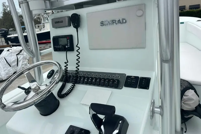Slide: The Image of 2014 Andros Tarpon 26 boat console with Simrad electronics and steering wheel. - 14
