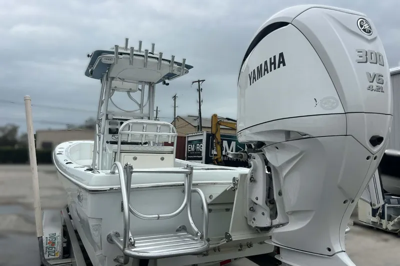 Slide: The Image of 2014 Andros Tarpon 26 boat with Yamaha 300 V6 engine, parked outdoors. - 22