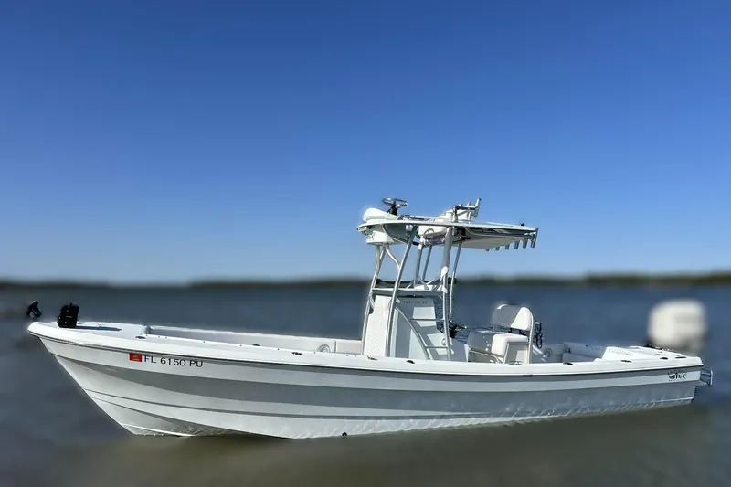 Slide: The Image of 2014 Andros Tarpon 26 boat on water, clear blue sky background. - 3