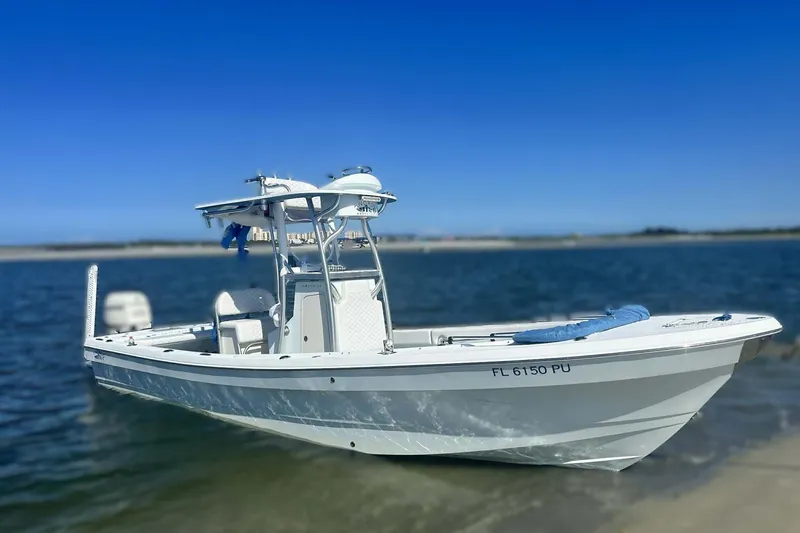 Slide: The Image of 2014 Andros Tarpon 26 boat on water, clear sky background. - 4