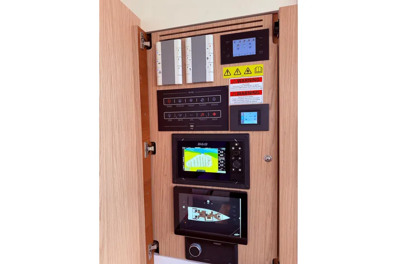 Slide: The Image of Control panel of 2022 Beneteau Oceanis Yacht 54 with navigation and warning displays. - 56