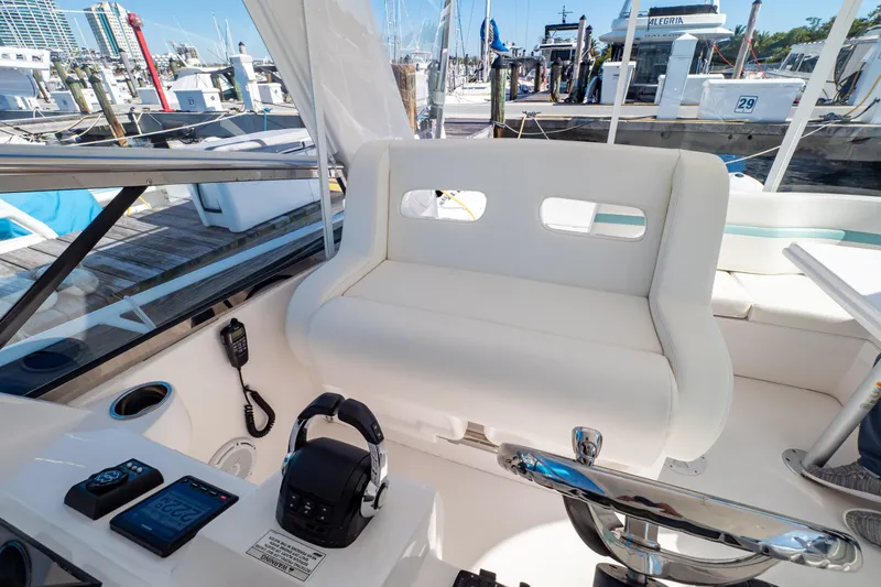 Slide: The Image of 2018 Intrepid 475 Sport Yacht cockpit with white seating and control panel. - 104