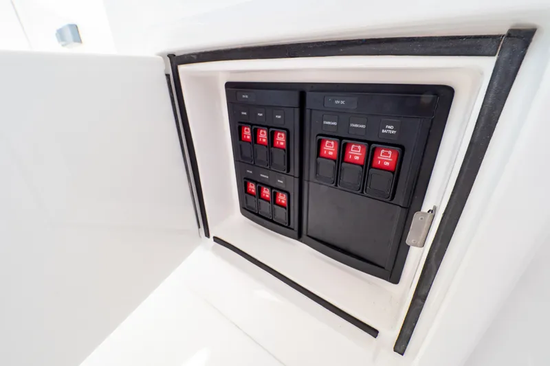 Slide: The Image of Control panel of a 2018 Intrepid 475 Sport Yacht with red switches. - 105
