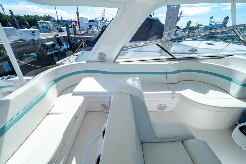Slide: The Image of Luxurious seating area on a 2018 Intrepid 475 Sport Yacht, docked at a marina. - 110