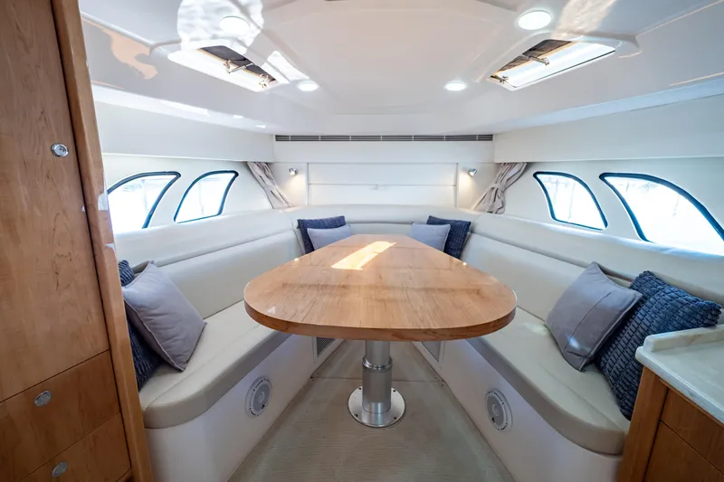 Slide: The Image of Luxurious interior of 2018 Intrepid 475 Sport Yacht with elegant seating and wooden table. - 12