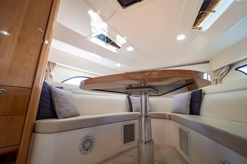 Slide: The Image of Interior of 2018 Intrepid 475 Sport Yacht with elegant seating and wooden table. - 122