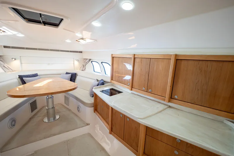 Slide: The Image of Luxurious interior of 2018 Intrepid 475 Sport Yacht with wooden cabinetry and seating area. - 125