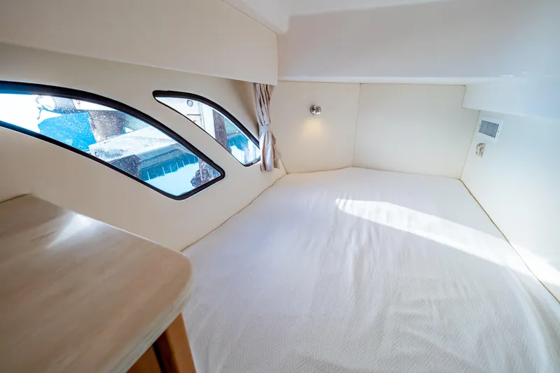 Slide: The Image of Interior cabin of 2018 Intrepid 475 Sport Yacht with large windows and cozy bed. - 133