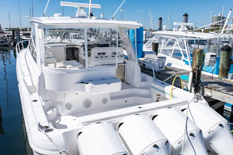 Slide: The Image of 2018 Intrepid 475 Sport Yacht docked at marina, showcasing sleek design and powerful engines. - 19