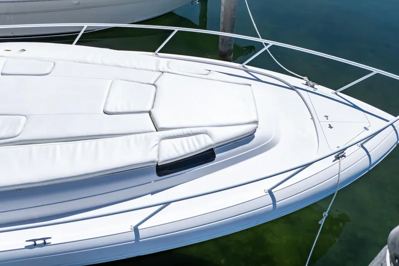 Slide: The Image of 2018 Intrepid 475 Sport Yacht with sleek white deck and railing, docked in clear water. - 21